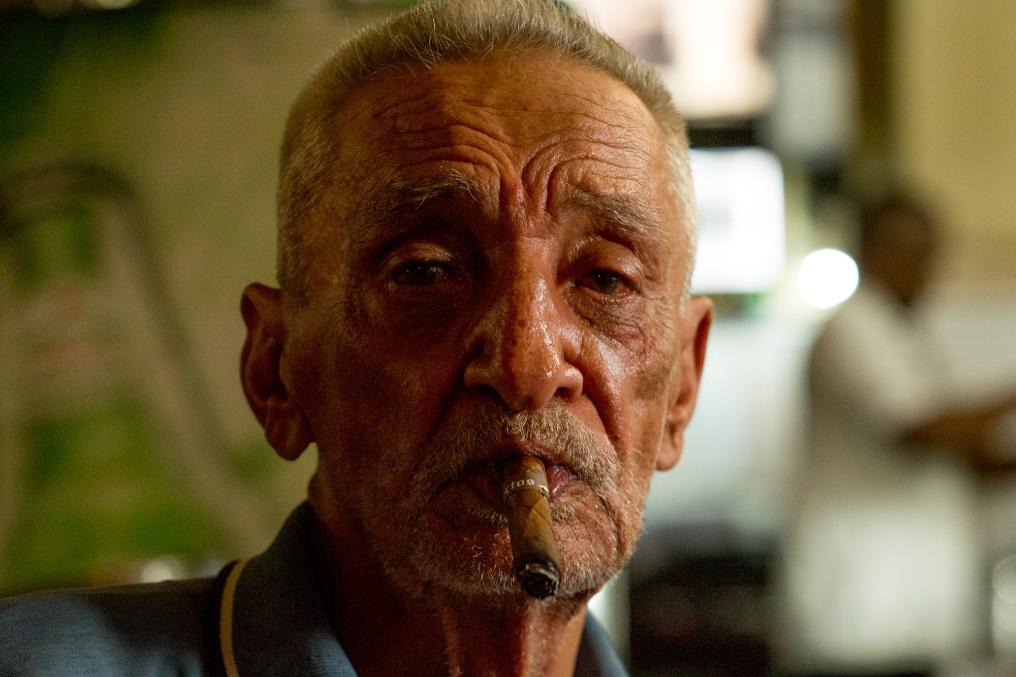 An old man smoking a cigar.