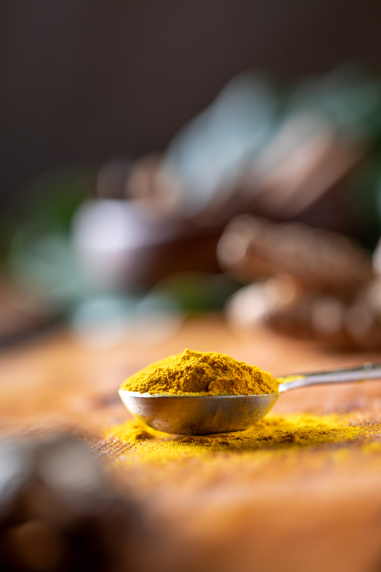 Turmeric spices on a measuring spoon