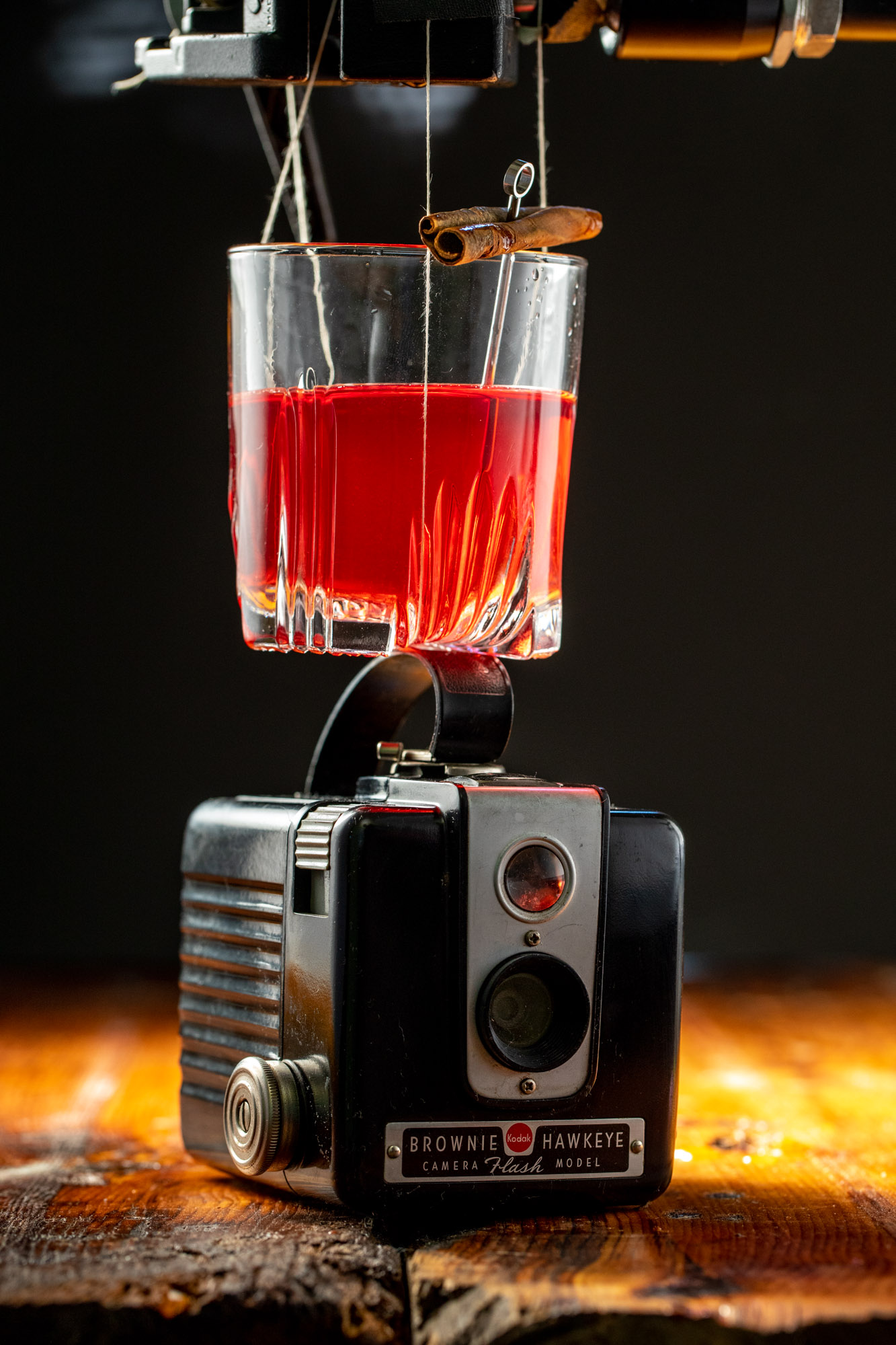 A creative portrait of a cocktail levitating over a camera