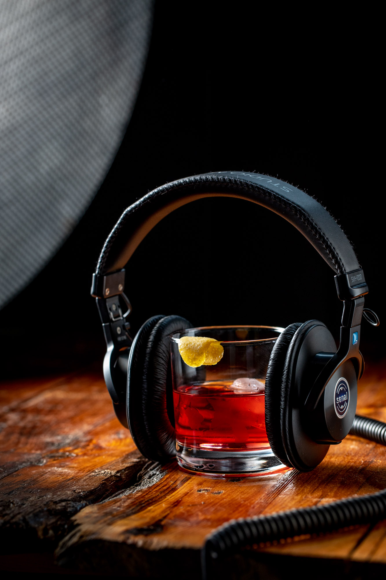 A cocktail with a pair of headphones listening to music