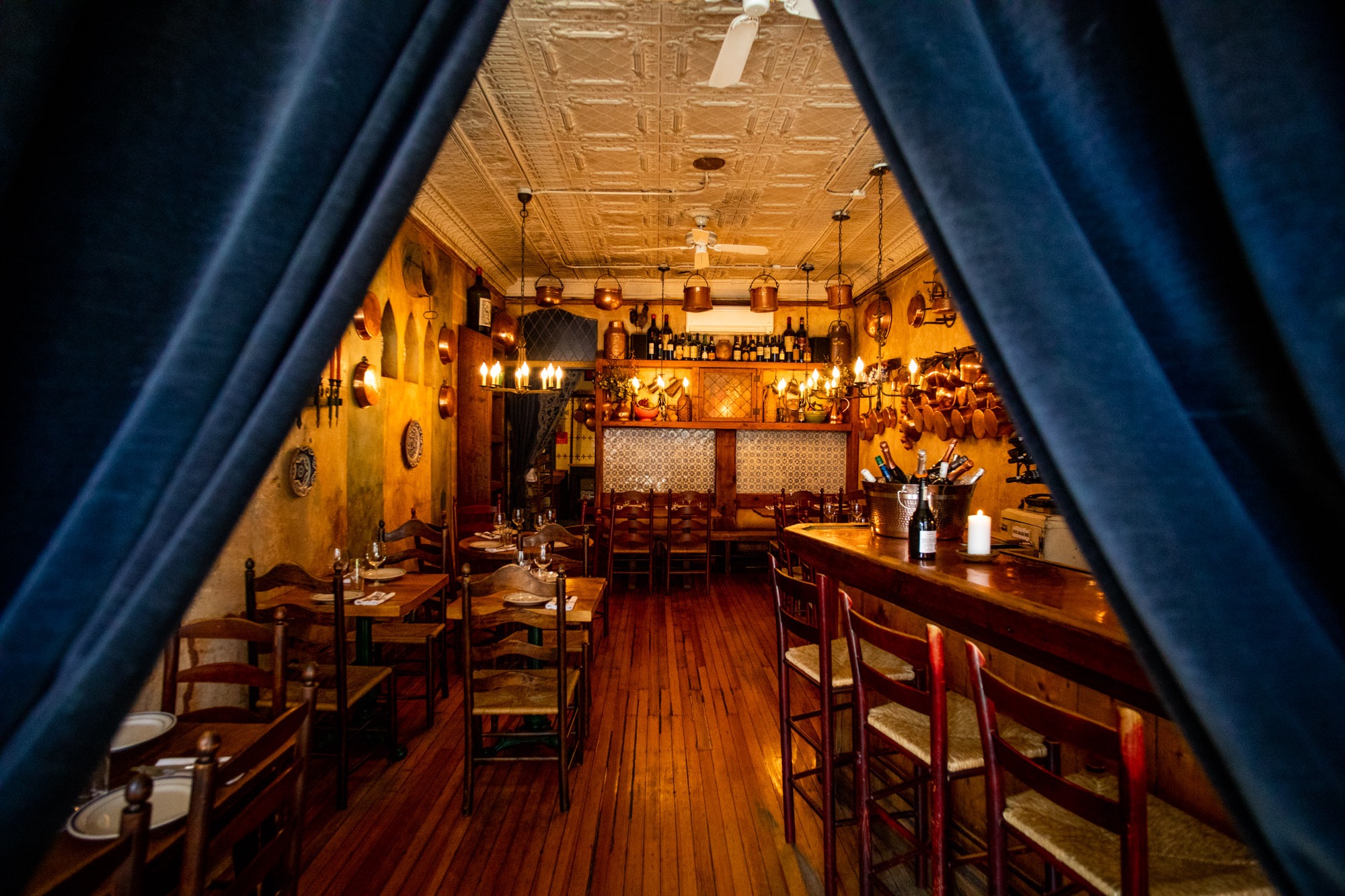 Curtains opening on the inteior of Convivium Osteria, an Italian restaurant in Brooklyn.